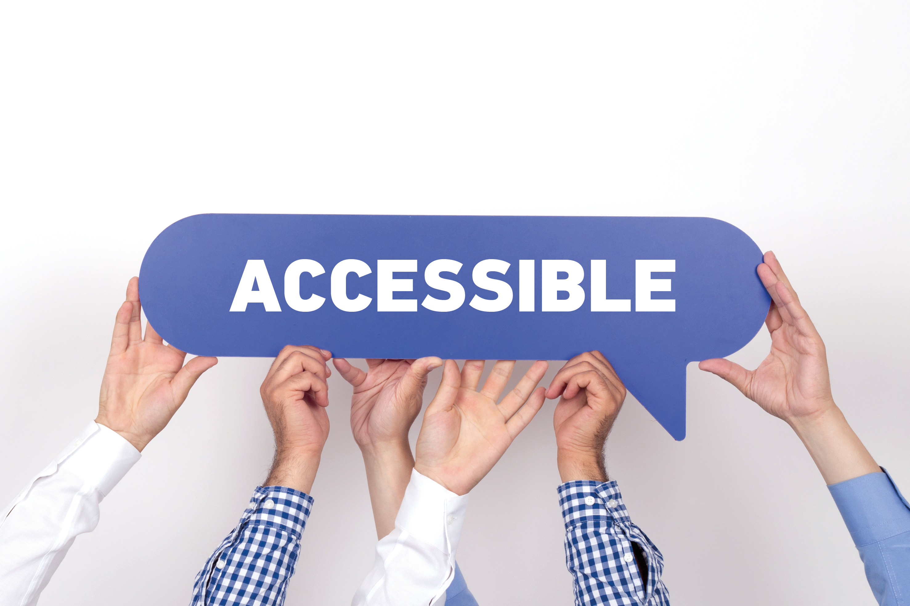 Varie mani reggono la scritta "accessible" per sensibilizzare sull'importanza delle WCAG 2.0